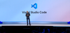 Microsoft CEO Satya Nadella speaks on stage at Microsoft Build in front of the Visual Studio Code logo.