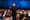 Salesforce CEO Marc Benioff speaks at Dreamforce 2025 in front of an audience wearing a black suit